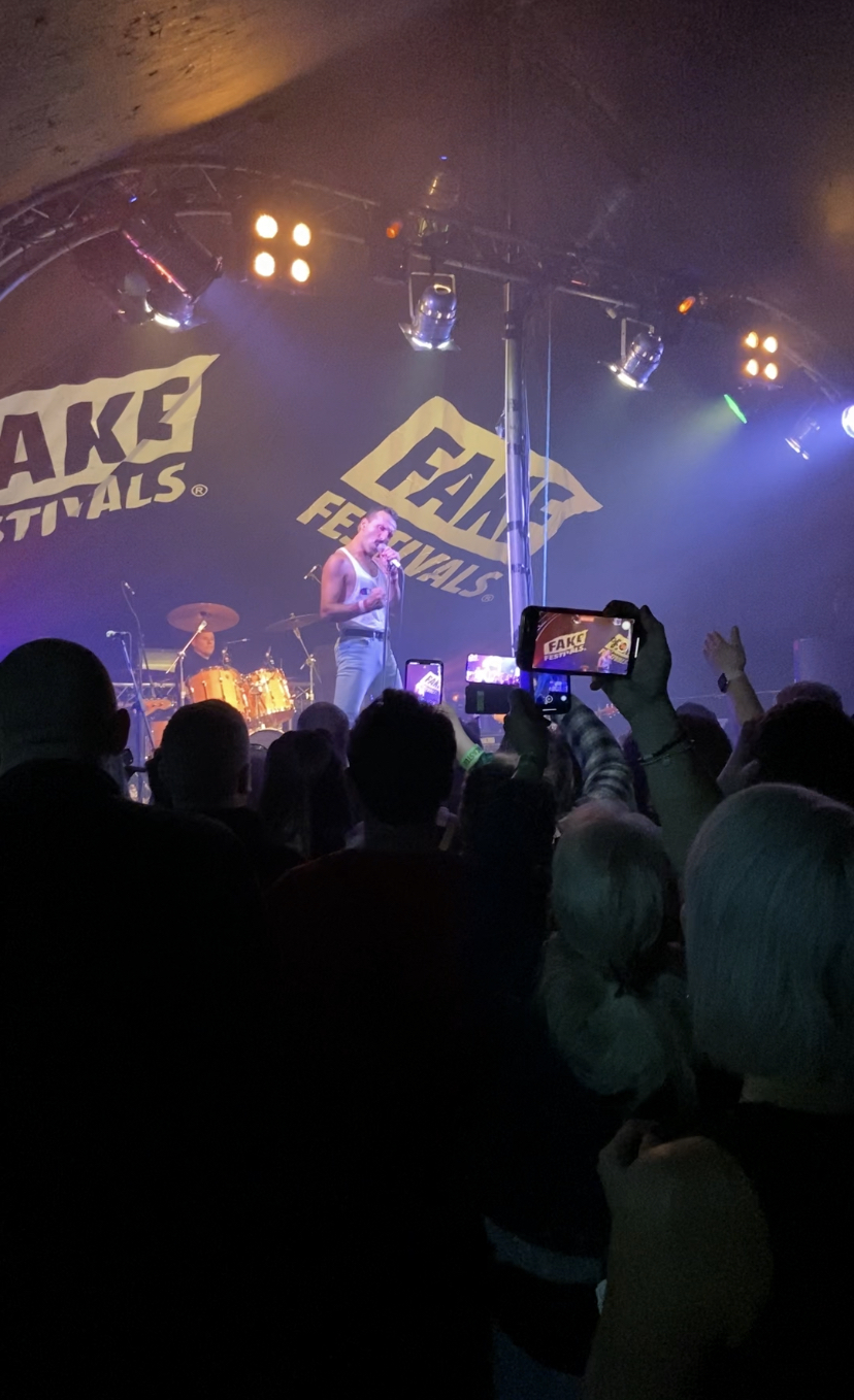 A crowd of concert goers taking pictures with their phones during a performace by Flash, A Tribute to Queen at Doncaster Fake Festival.